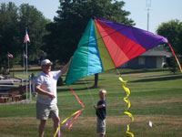 Tonawanda back pain free grandpa and grandson playing with a kite